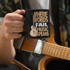 Music Speaks Black Mug 15oz - mockup of a musician holding an oz coffee mug - Shujaa Designs