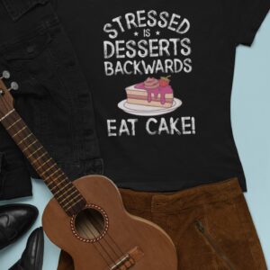 Stressed Is Desserts Backwards Eat Cake Unisex Jersey Short Sleeve Tee - outfit mockup featuring a t shirt next to a skirt and a ukulele - Shujaa Designs