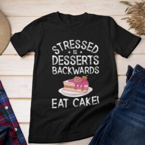 Stressed Is Desserts Backwards Eat Cake Unisex Jersey Short Sleeve Tee - round neck tee mockup featuring an outfit over a wooden surface r el - Shujaa Designs